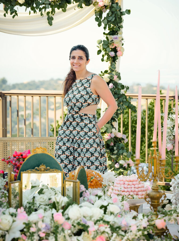 Woman in romper standing over Persian sofreh display