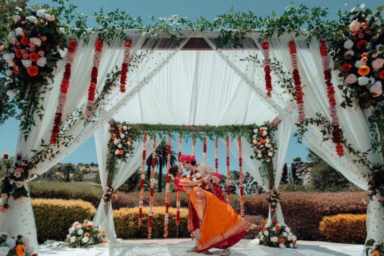 Indian-Mexican Wedding Ceremony at Silver Creek Country Club – A beautifully decorated outdoor wedding ceremony setting, blending vibrant Indian and Mexican elements, with the couple standing at the altar