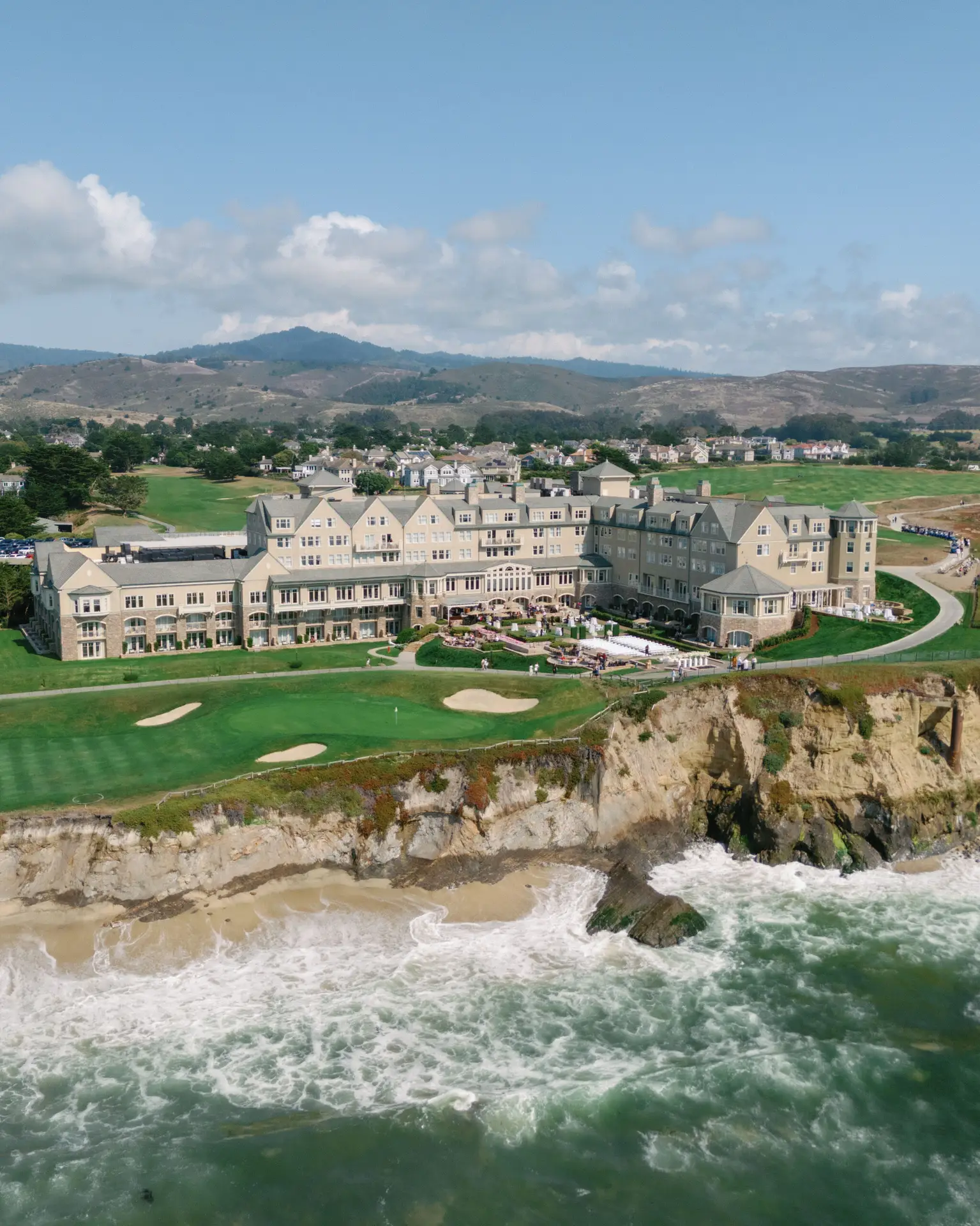 Exterior view of the Ritz-Carlton Half Moon Bay, showcasing its elegant architecture and stunning coastal backdrop.