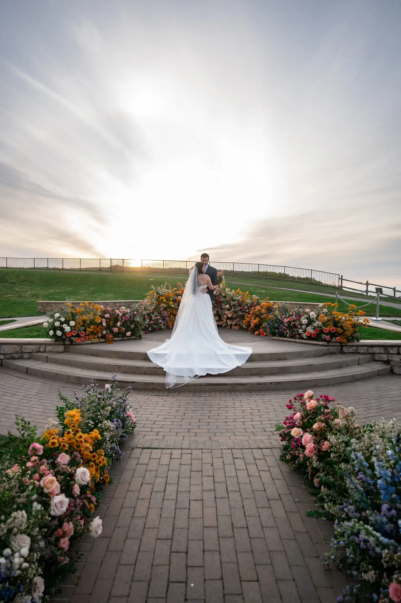 Wedding ceremony with vibrant spring florals and ocean view at The Ritz-Carlton Half Moon Bay.